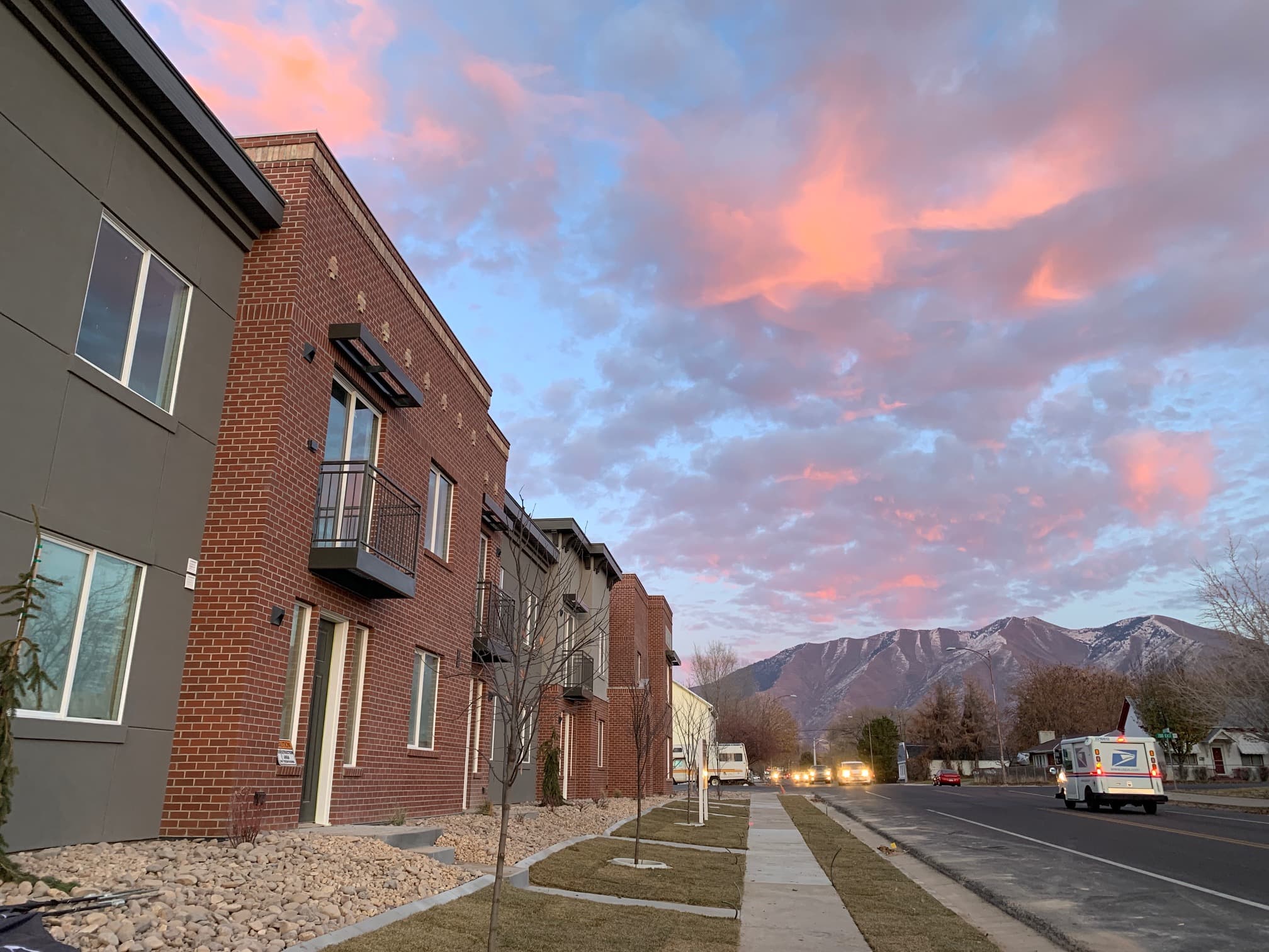 Rees Apartments street view with Wasatch Mountains and sunset sky