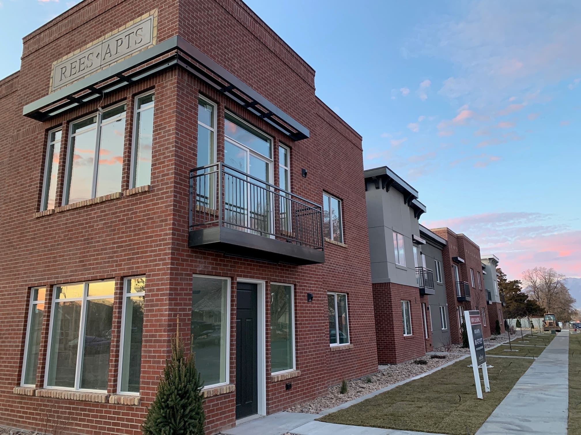 Rees Apartments building with REES APTS sign at golden hour